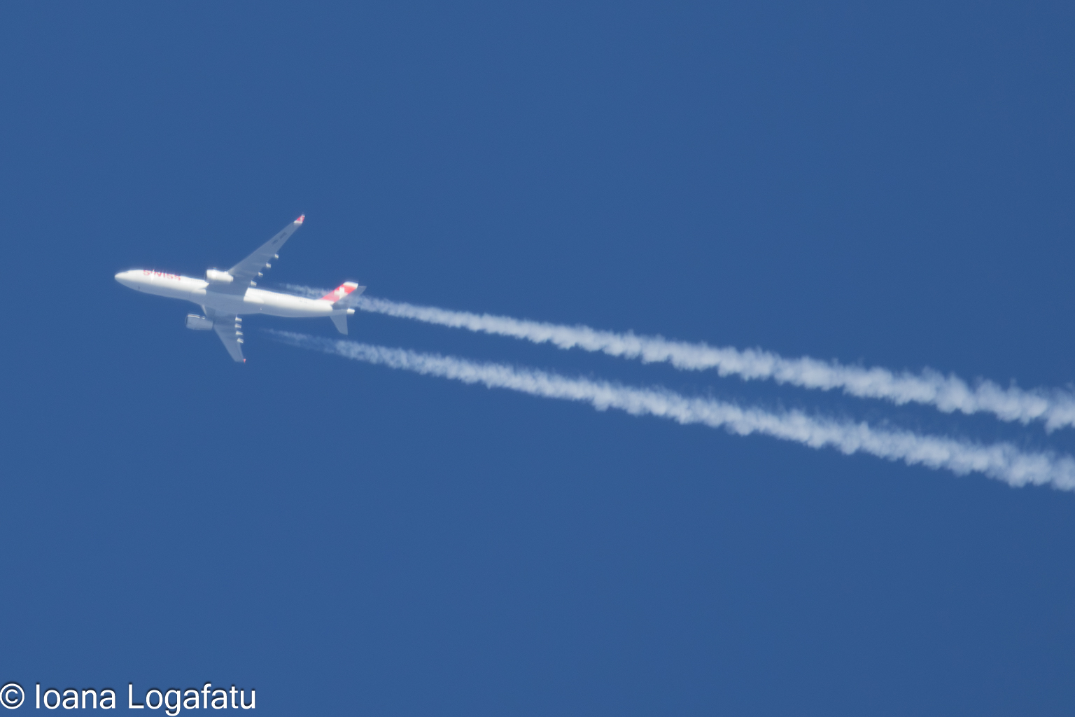 High above the clouds, a plane leaves its mark